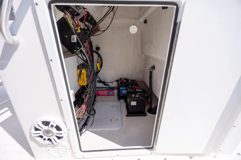 Slide: The Image of Interior view of 2022 Bay Rider 2260 Skiff's electrical compartment with wiring and battery setup. - 18