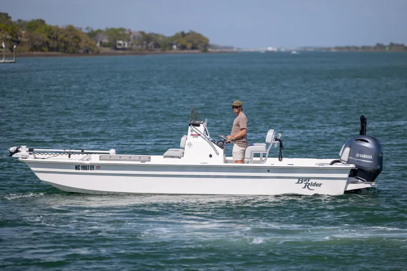 Slide: The Image of 2022 Bay Rider 2260 Skiff on water with driver, featuring Yamaha engine. - 4