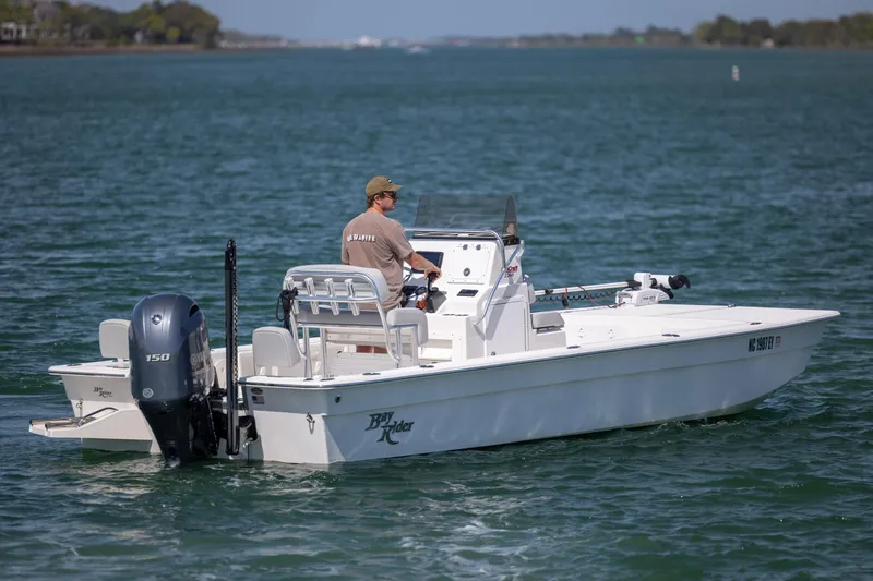 Slide: The Image of 2022 Bay Rider 2260 Skiff on water, operated by a person, with Yamaha outboard motor. - 7