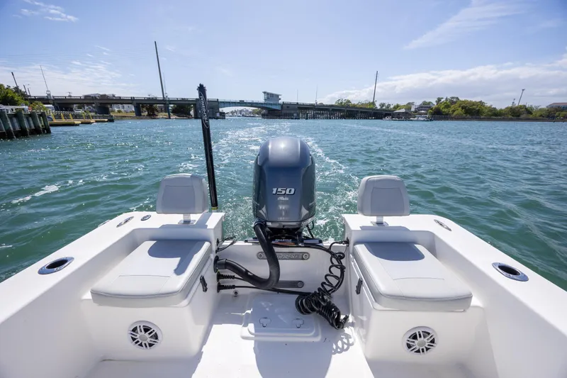 Slide: The Image of Bay Rider 2260 Skiff 2022 on water, showcasing outboard motor and seating. - 8