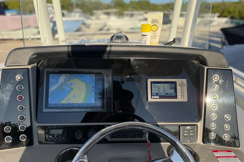 Slide: The Image of 2019 Robalo R242 Center Console dashboard with navigation screens and controls. - 2