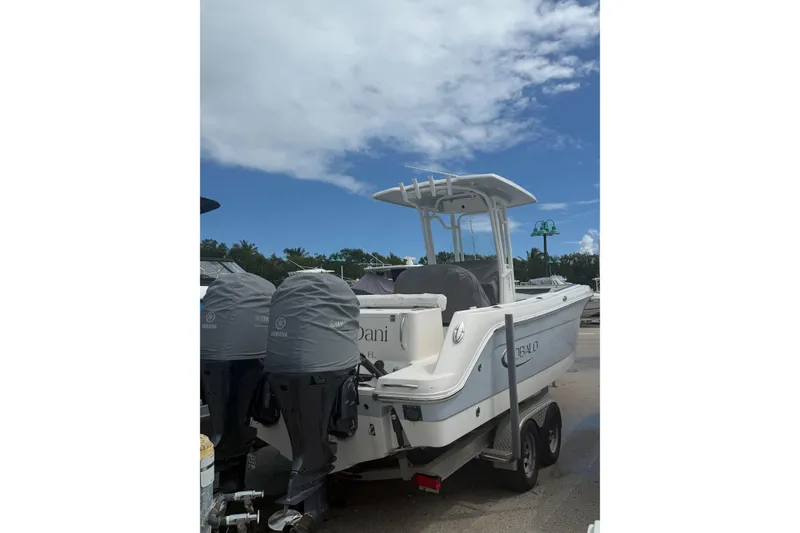 Slide: The Image of 2019 Robalo R242 Center Console boat on trailer under blue sky. - 4