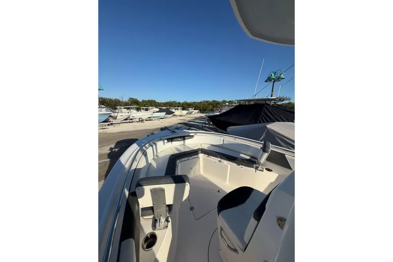 Slide: The Image of 2019 Robalo R242 Center Console boat docked under clear blue sky. - 5