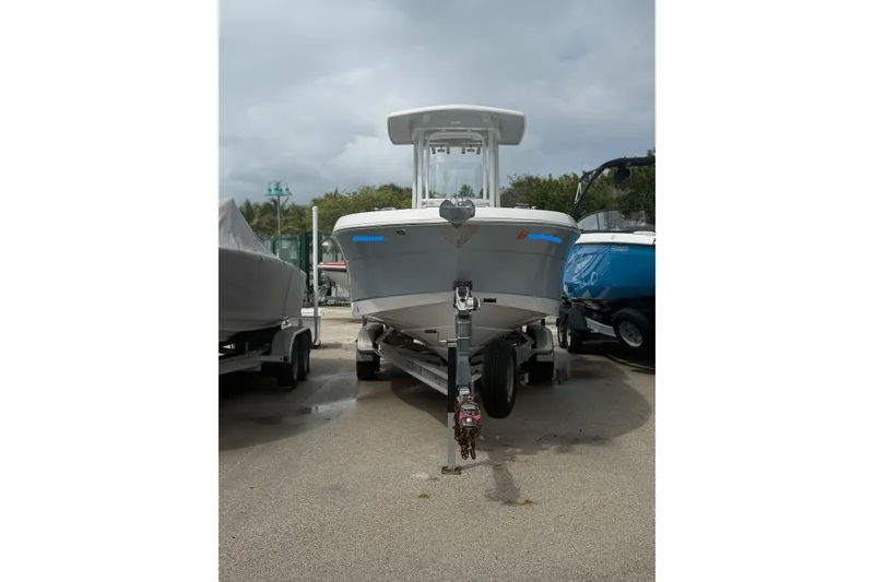 Slide: The Image of 2019 Robalo R242 Center Console boat on trailer, parked outdoors. - 6