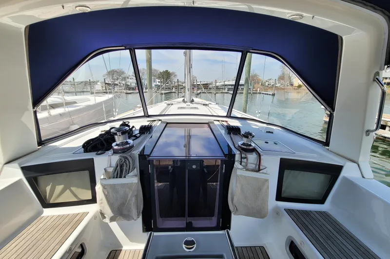 Slide: The Image of Cockpit view of 2015 Beneteau Oceanis 45 sailboat, featuring modern design and marina backdrop. - 13