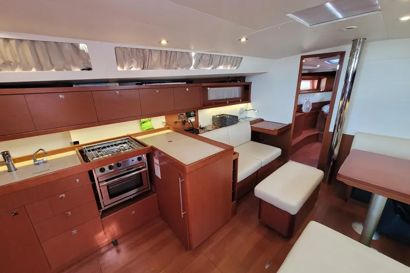 Slide: The Image of Interior of 2015 Beneteau Oceanis 45 yacht with modern kitchen and seating area. - 15