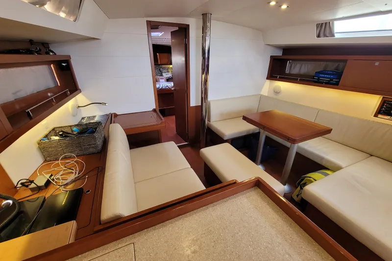 Slide: The Image of Interior of 2015 Beneteau Oceanis 45 yacht, featuring cozy seating and modern design. - 16