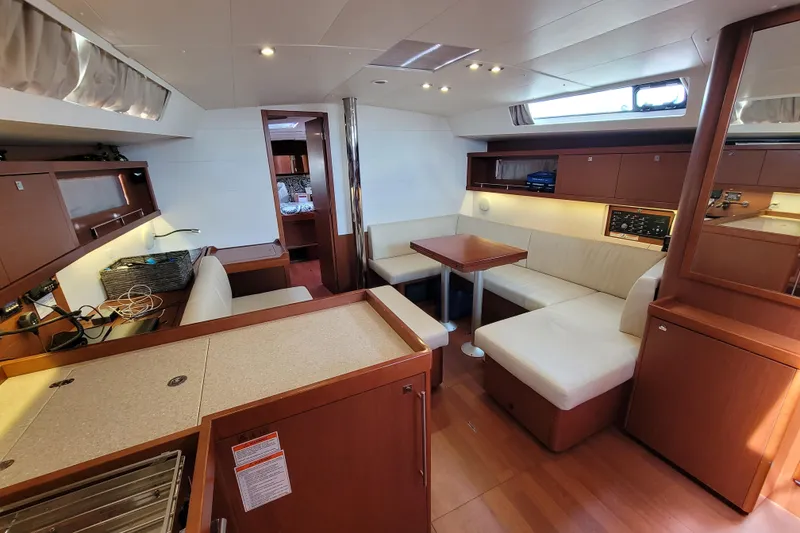 Slide: The Image of Interior of 2015 Beneteau Oceanis 45 yacht with modern seating and wooden finishes. - 17