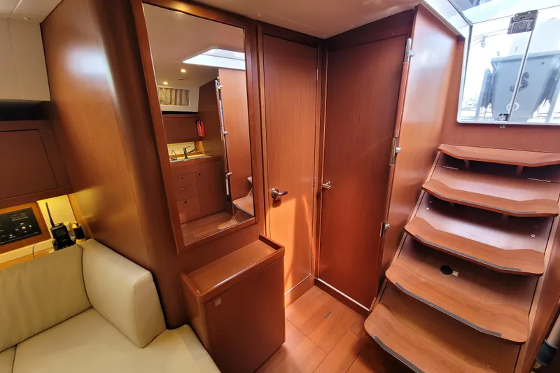 Slide: The Image of Interior of 2015 Beneteau Oceanis 45 yacht with wooden stairs and cabinetry. - 26