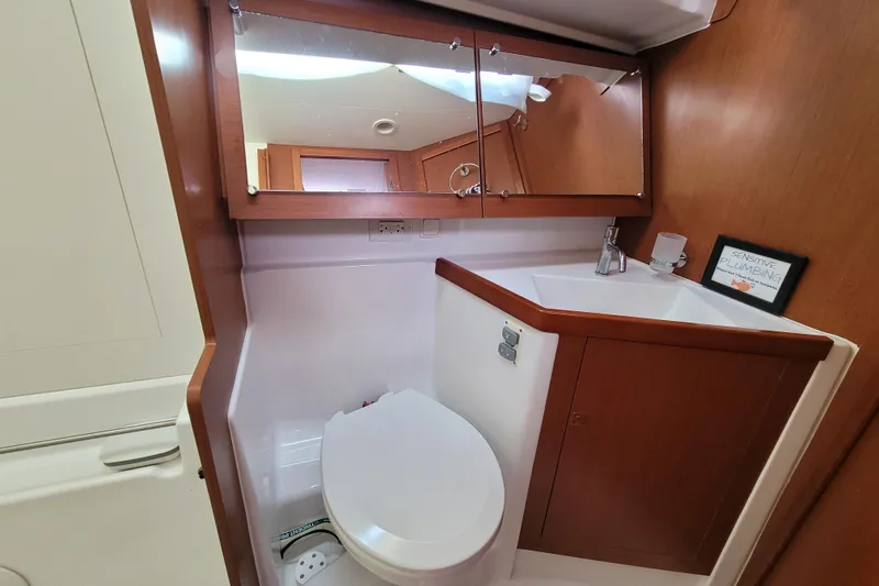 Slide: The Image of Bathroom interior of 2015 Beneteau Oceanis 45 yacht, featuring wooden cabinetry and modern fixtures. - 27
