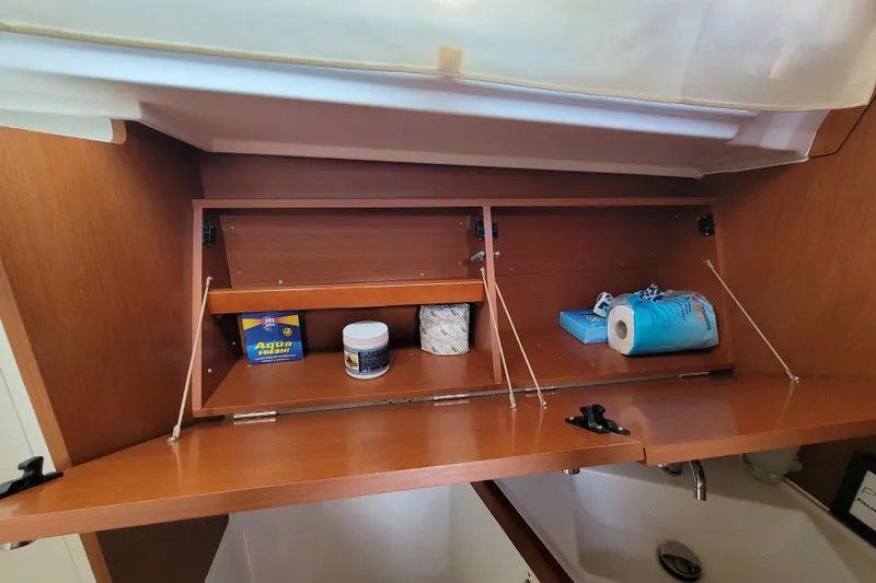 Slide: The Image of Wooden cabinet storage in a 2015 Beneteau Oceanis 45 yacht bathroom. - 28