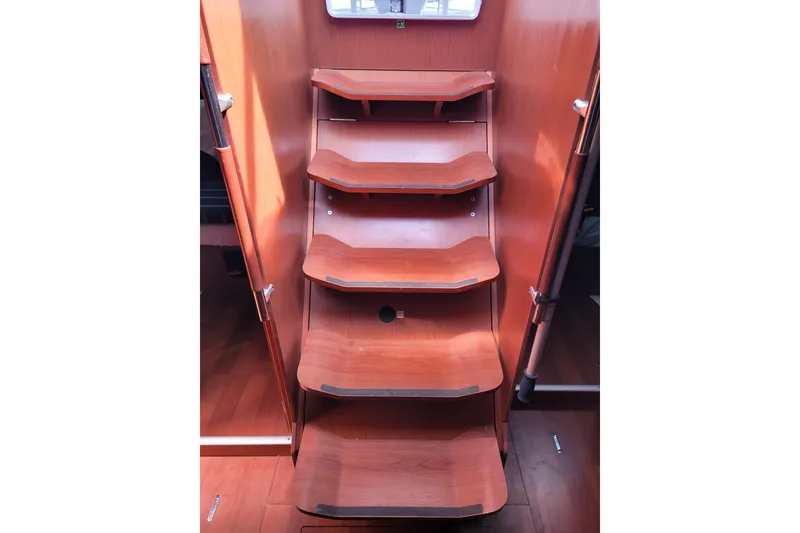 Slide: The Image of Wooden staircase inside 2015 Beneteau Oceanis 45 yacht, featuring sleek design and polished finish. - 33