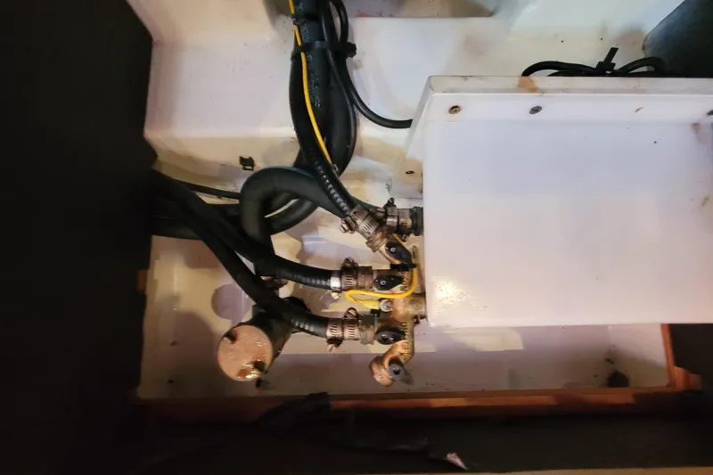 Slide: The Image of Engine compartment of a 2015 Beneteau Oceanis 45 sailboat, showing hoses and connections. - 38