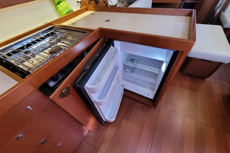 Slide: The Image of Interior of 2015 Beneteau Oceanis 45 yacht kitchen with stove and open fridge. - 41