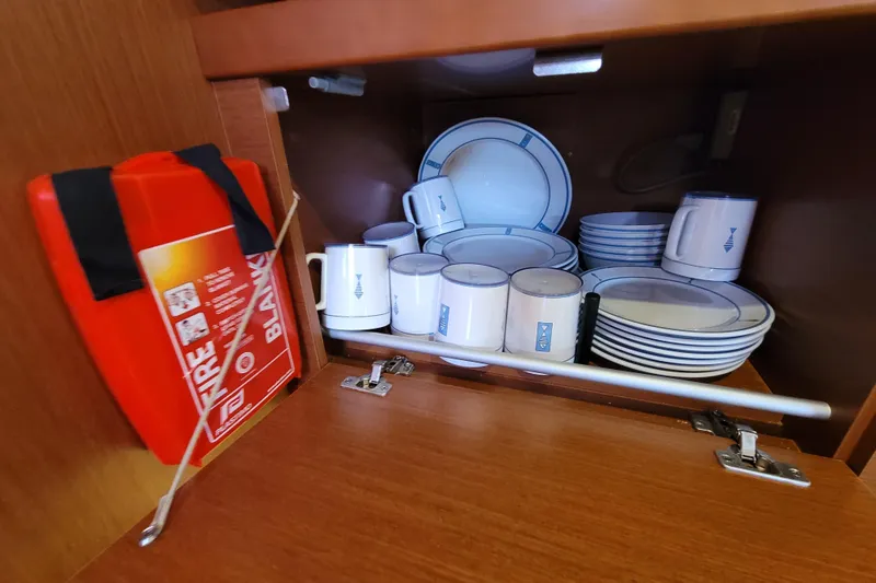 Slide: The Image of Cabinet in 2015 Beneteau Oceanis 45 yacht with dishes and fire blanket. - 44