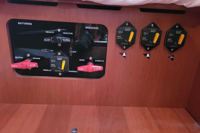 Slide: The Image of Control panel of a 2015 Beneteau Oceanis 45 yacht, featuring battery switches and breakers. - 45