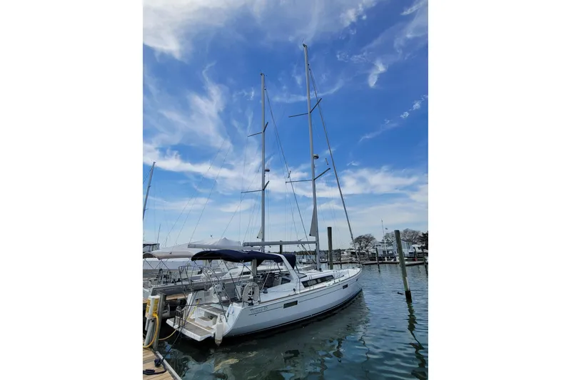 Slide: The Image of 2015 Beneteau Oceanis 45 sailboat docked under a clear blue sky. - 5