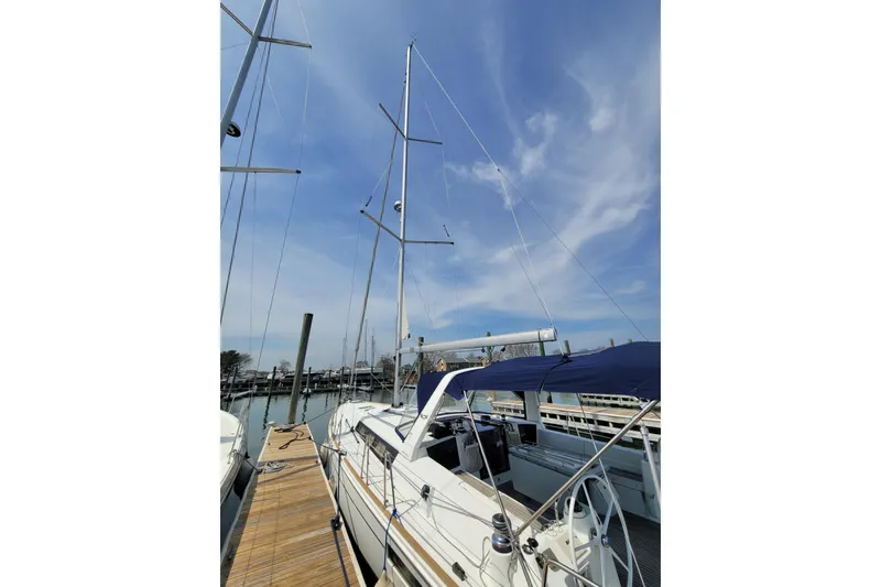 Slide: The Image of 2015 Beneteau Oceanis 45 sailboat docked under a clear blue sky. - 6