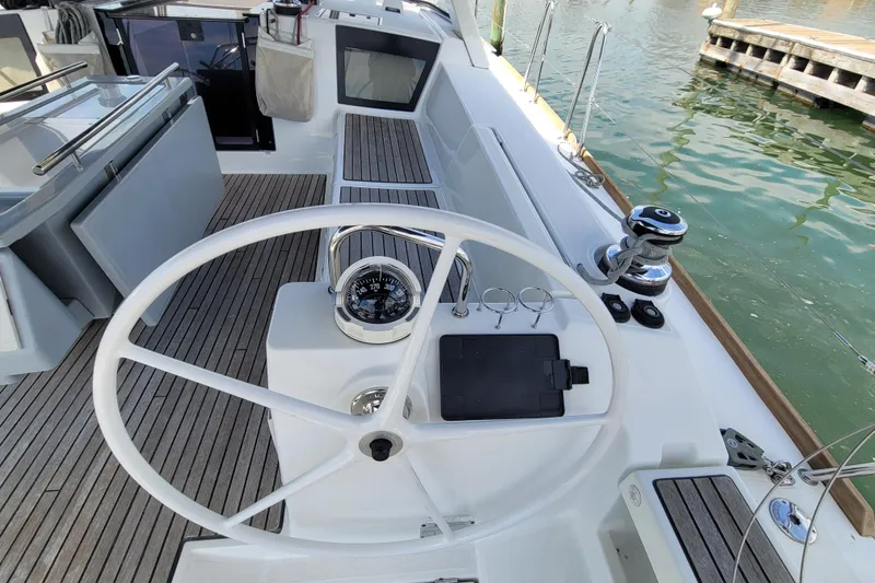Slide: The Image of Cockpit of 2015 Beneteau Oceanis 45 sailboat with steering wheel and navigation instruments. - 9
