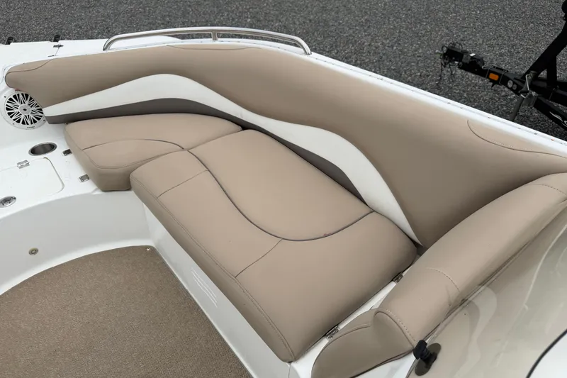 Slide: The Image of 2016 Hurricane SunDeck Sport 202 OB boat interior with beige seating and speaker. - 10