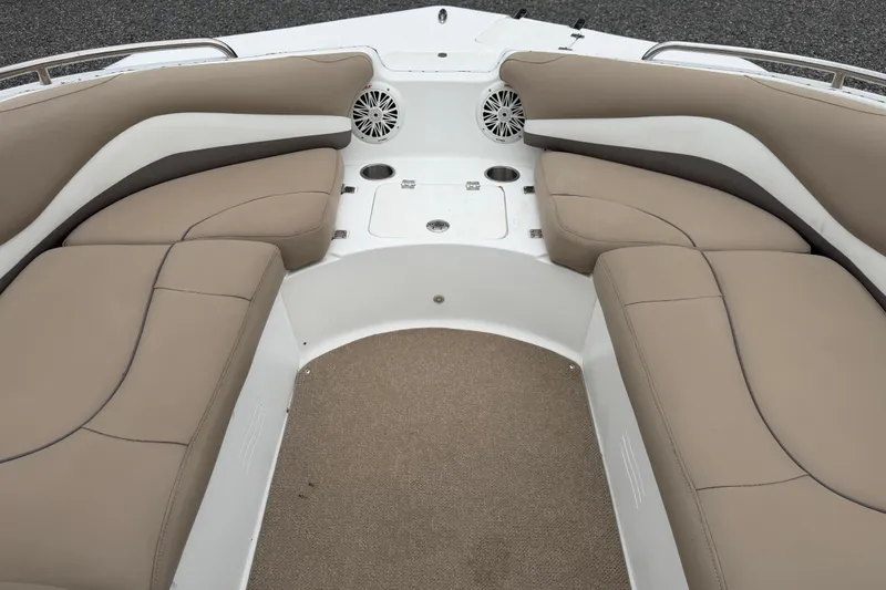 Slide: The Image of Interior view of 2016 Hurricane SunDeck Sport 202 OB boat with beige seating and cup holders. - 11