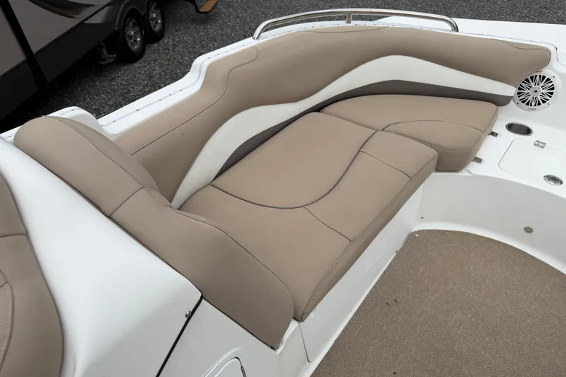 Slide: The Image of 2016 Hurricane SunDeck Sport 202 OB boat interior with beige seating and speaker. - 12