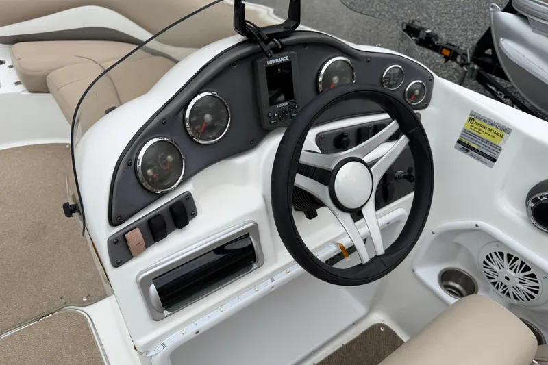 Slide: The Image of 2016 Hurricane SunDeck Sport 202 OB boat dashboard with steering wheel and gauges. - 13