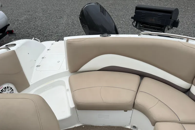 Slide: The Image of 2016 Hurricane SunDeck Sport 202 OB boat interior with beige seating and motor. - 16