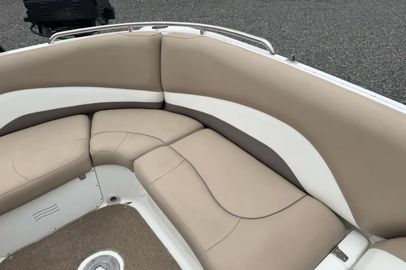 Slide: The Image of 2016 Hurricane SunDeck Sport 202 OB boat interior with beige and white cushioned seating. - 17