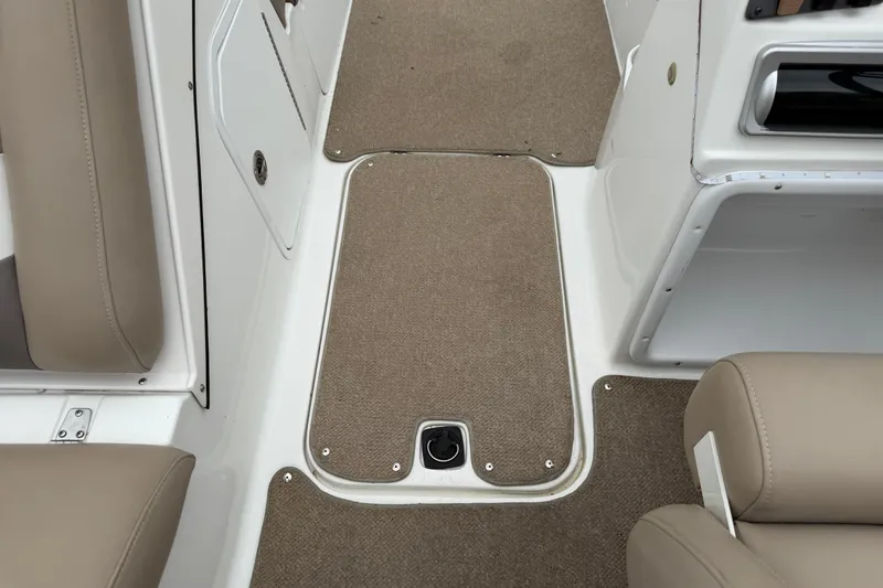 Slide: The Image of Interior view of 2016 Hurricane SunDeck Sport 202 OB boat with beige seating and carpeted flooring. - 19