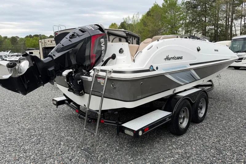 Slide: The Image of 2016 Hurricane SunDeck Sport 202 OB boat on trailer with Evinrude outboard motor. - 3