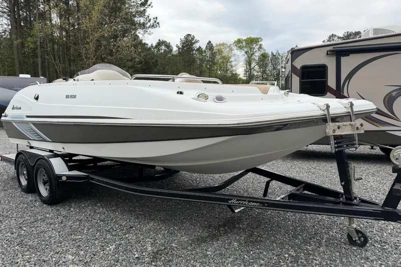 Slide: The Image of 2016 Hurricane SunDeck Sport 202 OB boat on trailer, parked outdoors. - 4
