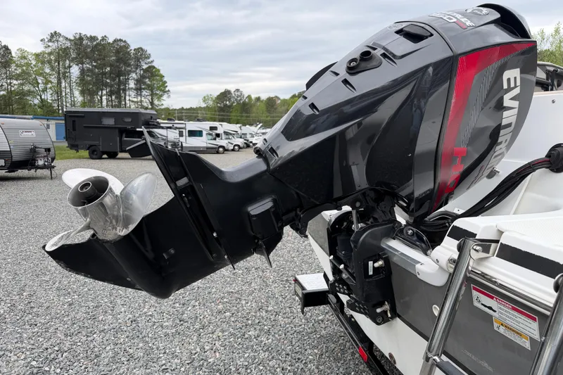 Slide: The Image of 2016 Hurricane SunDeck Sport 202 OB with Evinrude outboard motor in a parking lot. - 6