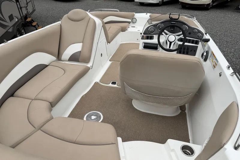 Slide: The Image of 2016 Hurricane SunDeck Sport 202 OB interior with beige seating and modern dashboard. - 8