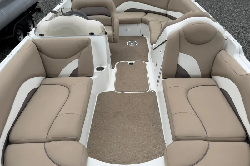 Slide: The Image of 2016 Hurricane SunDeck Sport 202 OB boat interior with beige seating and carpeted floor. - 9