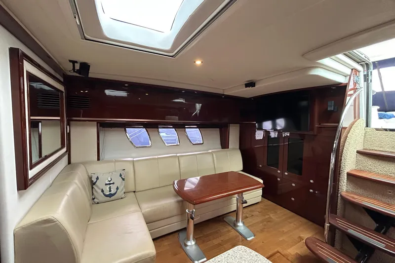 Slide: The Image of Luxurious interior of 2009 Sea Ray 480 Sundancer yacht with plush seating and wooden accents. - 13