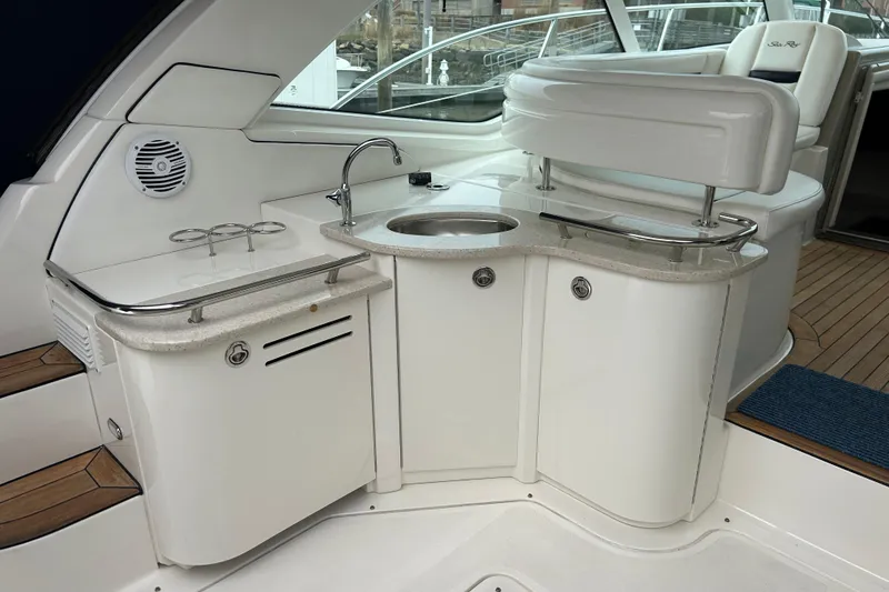Slide: The Image of Luxurious 2009 Sea Ray 480 Sundancer yacht interior with sleek kitchenette and seating area. - 4