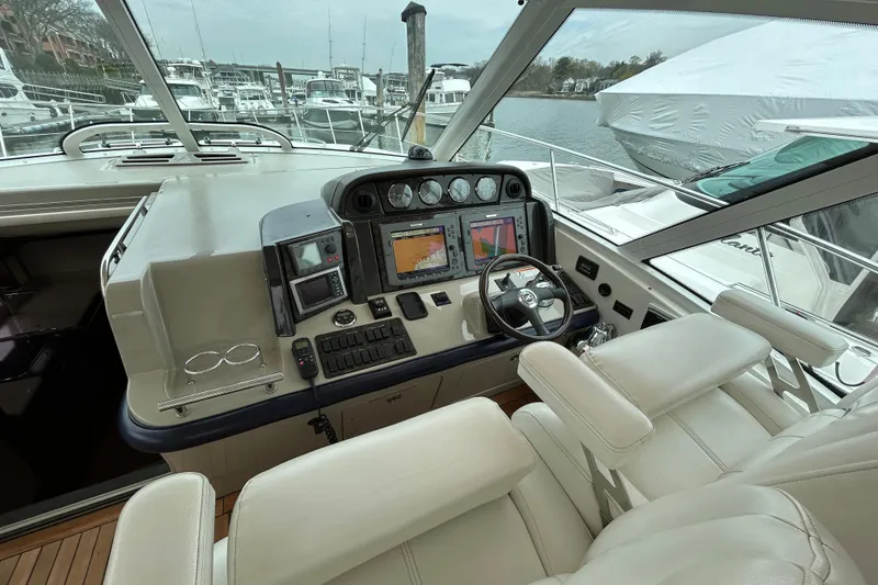 Slide: The Image of Helm of 2009 Sea Ray 480 Sundancer with navigation equipment and luxurious seating. - 8