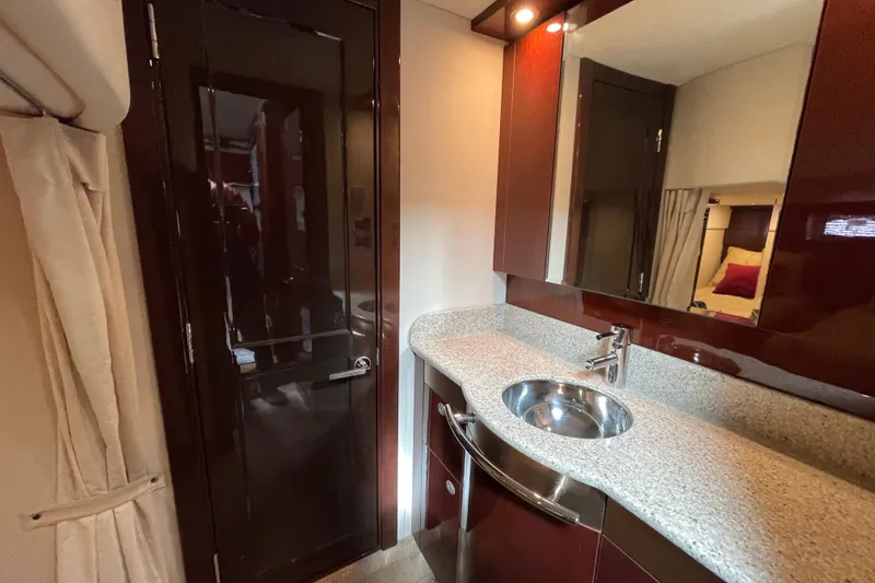 Slide: The Image of Luxurious bathroom interior of 2009 Sea Ray 480 Sundancer yacht with modern sink and cabinetry. - 19
