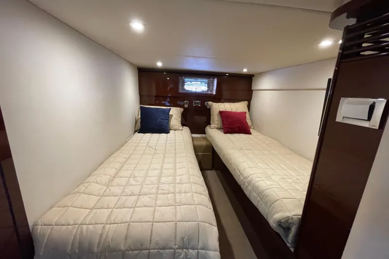 Slide: The Image of Interior cabin of 2009 Sea Ray 480 Sundancer with twin beds and cozy lighting. - 21
