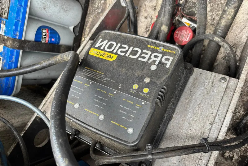 Slide: The Image of Battery charger and cables in a 2016 Skeeter ZX200 boat compartment. - 12