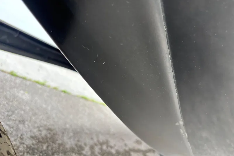 Slide: The Image of Close-up of a 2016 Skeeter ZX200 boat hull, showing sleek design and surface details. - 2