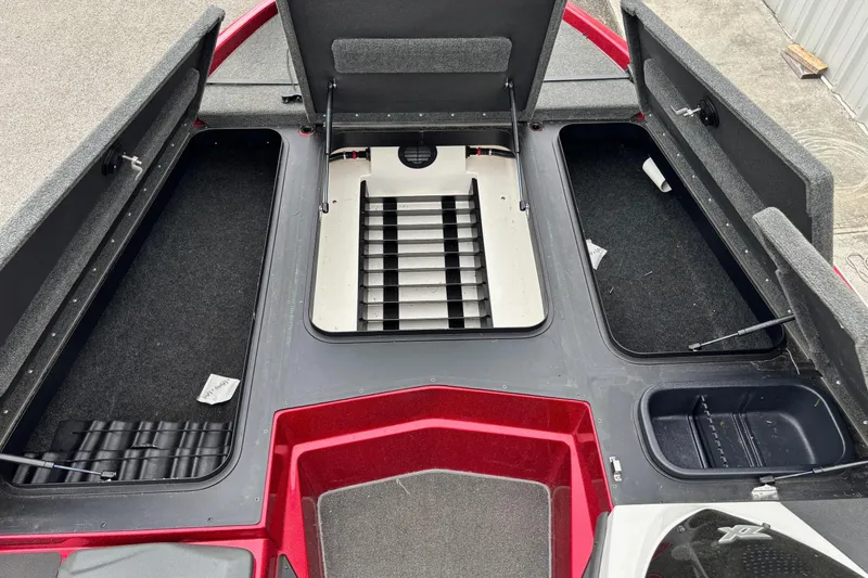 Slide: The Image of 2016 Skeeter ZX200 boat storage compartments with open hatches, showcasing interior layout. - 6