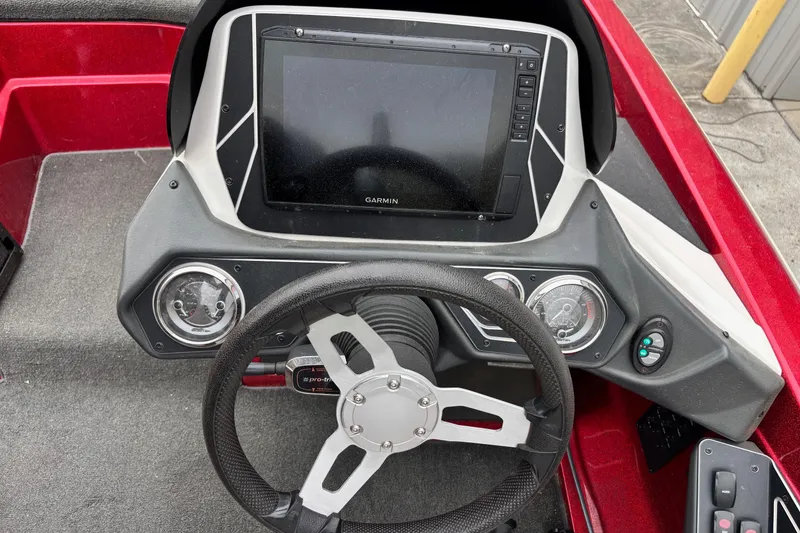 Slide: The Image of 2016 Skeeter ZX200 boat dashboard with Garmin display and steering wheel. - 8