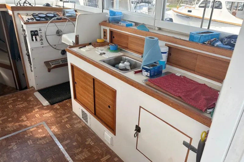 Slide: The Image of Interior of a 1980 Custom Chesapeake boat with steering wheel and kitchenette. - 10