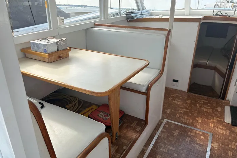 Slide: The Image of Interior of a 1980 Custom Chesapeake boat with a cozy dining area. - 11