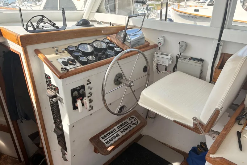 Slide: The Image of Helm of 1980 Custom Chesapeake boat with gauges, steering wheel, and marine equipment. - 13