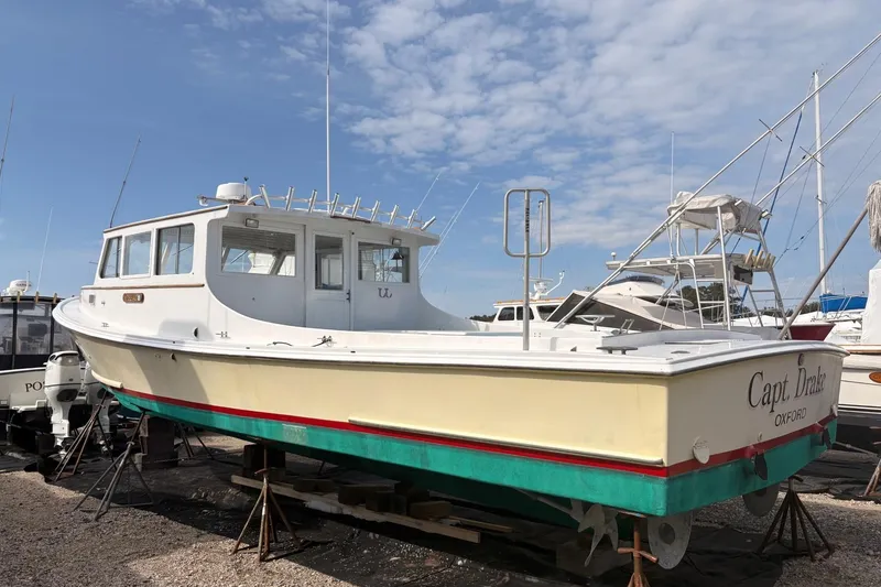 Slide: The Image of Custom 1980 Chesapeake boat on dry dock under a clear blue sky. - 3