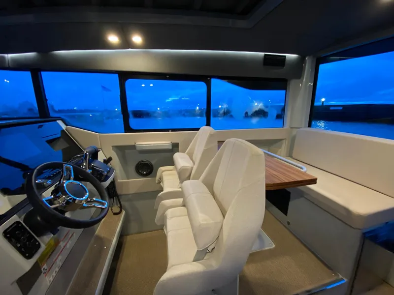 Slide: The Image of Interior of 2025 Saxdor 320 GTC boat with modern seating and steering console. - 17