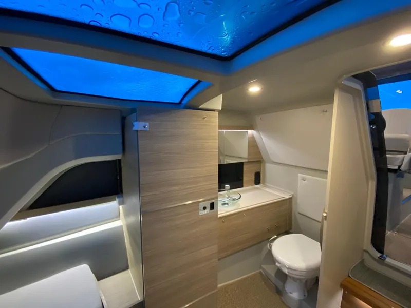 Slide: The Image of Modern interior of Saxdor 320 GTC 2025 boat with skylight, bathroom, and wooden cabinetry. - 19